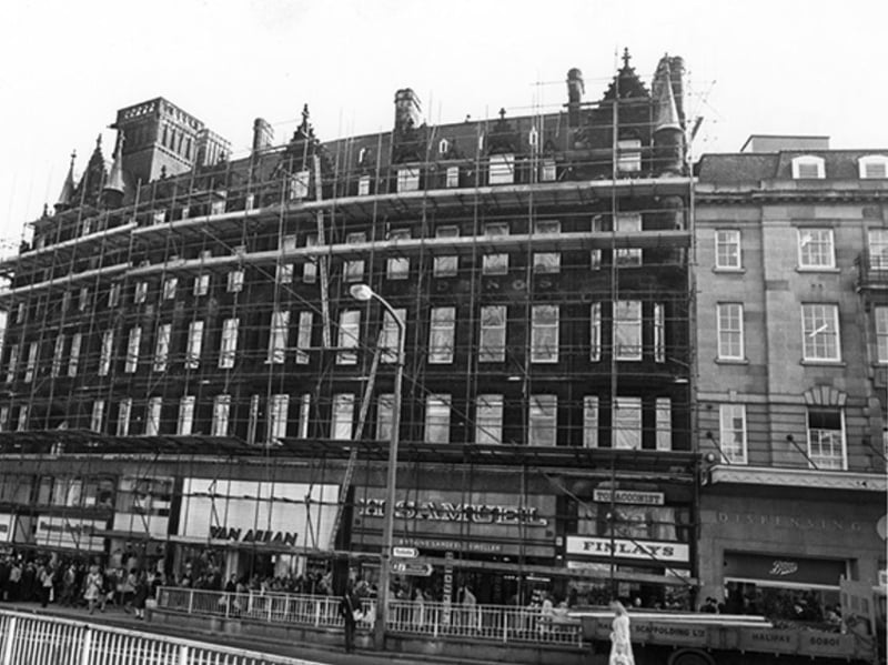 The Norwich Union Building on High Street, Sheffield city centre, during refurbishment in 1981, with shops including Finlays and Co tobacconists, H. Samuel jewellers Van Allan ladies outfitters, and Freeman Hardy Willis shoe shop