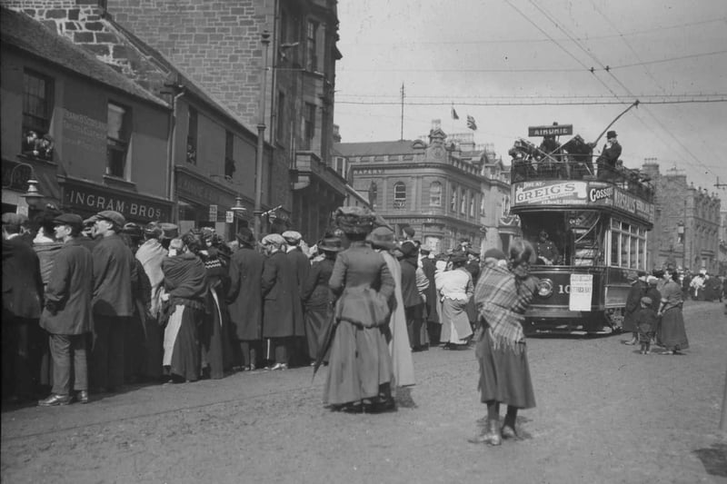 Crowds congregate on Stirling Street, Airdrie to celebrate the Coronation on 23 June 1911. Airdrie and Coatbridge Tramway Company tramcar No.10 can be seen on the right.