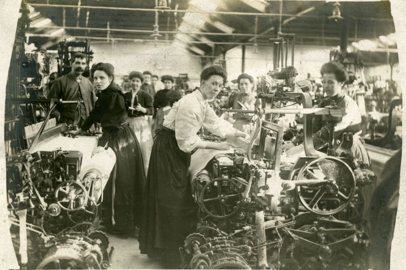 These women are posing with their power looms inside Thomas Goldie and Company's cotton mill at Rawyards, to the north of Airdrie.The overwhelming majority of workers in the mill were women and those we see here are wearing their hair up to avoid it becoming entangled in the machinery.