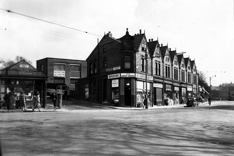 Shops at numbers 576 and 582 Meanwood Road, at the junction with Stonegate Road. To the left is W. Gibson, Confectioner and Tobacconist. To the right is R.C. Hopkinson Ltd., grocers and J. Bradbury and Sons, pork butchers. To the rear is the Snow White Laundry. Pictured in April 1951.