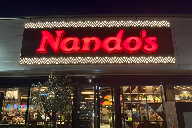 The illuminated red Nando's logo outside the new restaurant in New Brighton, which opens on Tuesday.