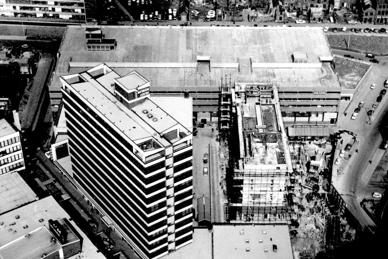 A  partially completed Merrion Centre pictured in April 1965., It was opened on May 26 1964. It then included a cinema, ballroom, bowling alley and shops. Merrion Way is on the right, Merrion Street on the left. Wade Lane is running left to right in front of the centre.