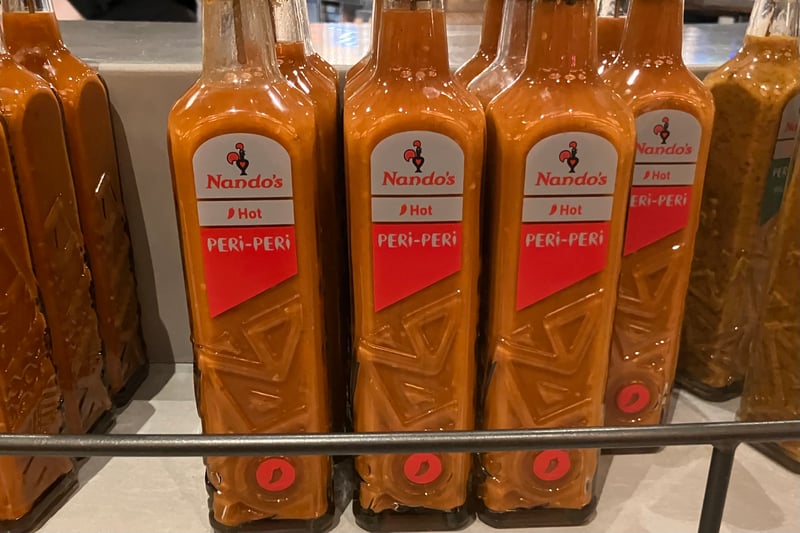 Plenty of bottles of Nando's famous hot PERi-PERi sauce. 