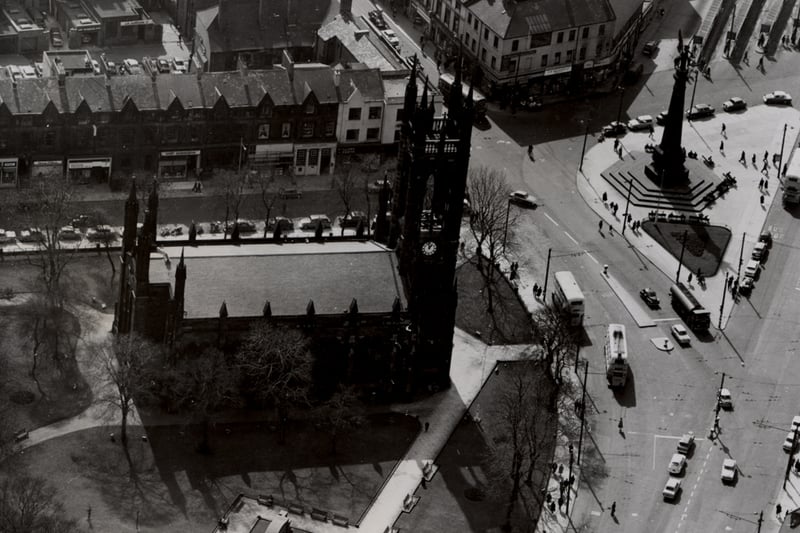 An aerial view of St. Thomas' Church Barras Bridge Newcastle upon Tyne taken in 1964. The First World War memorial is in the foreground to the left St. Thomas Church is in the centre to the left and the South African War memorial to the right. The South African War memorial is in the middle of a traffic island. Buildings on St. Mary's Place Northumberland Street and the Haymarket can be seen in the background.