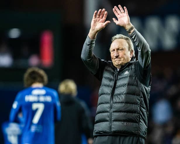 Aberdeen manager Neil Warnock waves to the travelling fans at full time 