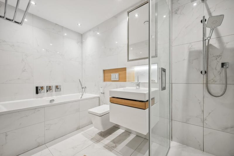 The en-suite bathroom has both a shower and bathtub with a separate shower function. 