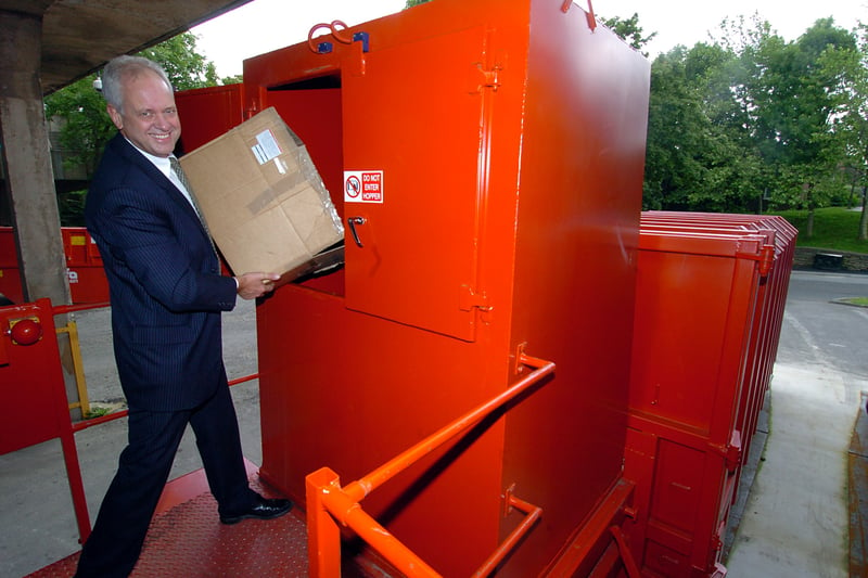 Centre manager Ian Hurst recycling bits into the new compactor at Bramley Shopping Centre in July 2007.