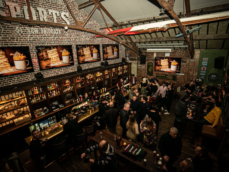 The main hall blends traditional British elements with modern flourishes, stripping back the walls to its original form