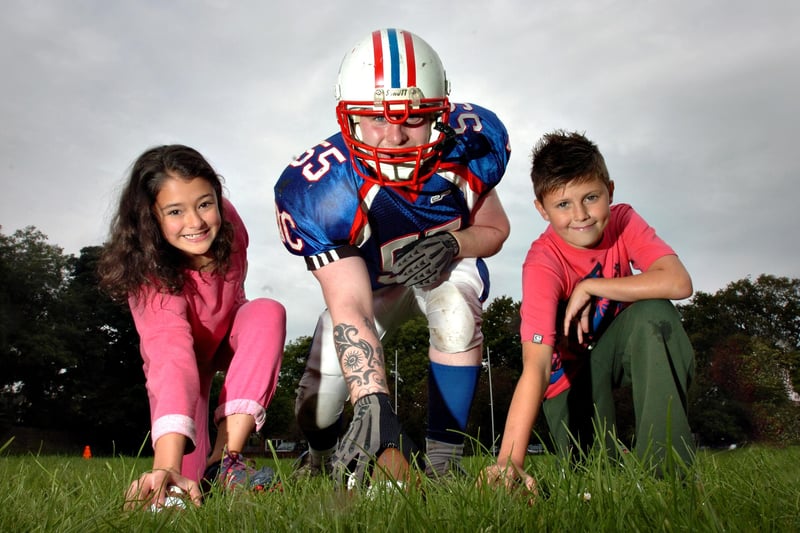 Jake Howe from the Durham based DC Presidents American Football team with Lauren Said and Lewis Pitcairn, both aged 11. American Sports Camp