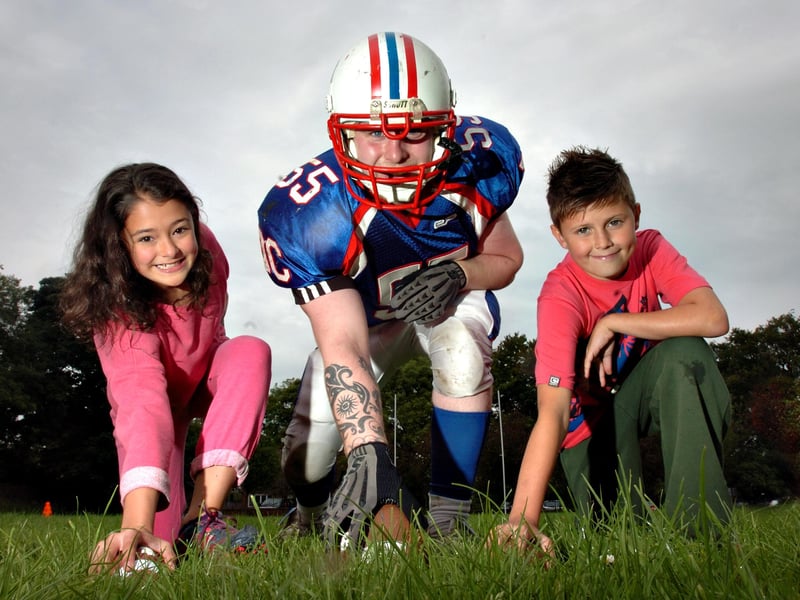 Jake Howe from the Durham based DC Presidents American Football team with Lauren Said and Lewis Pitcairn, both aged 11. American Sports Camp