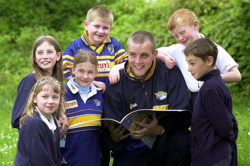 Leeds Rhinos star Ewan Dowes reads to some of the pupils at Kippax North Junior School during their Read to Succeed day in May 2001.