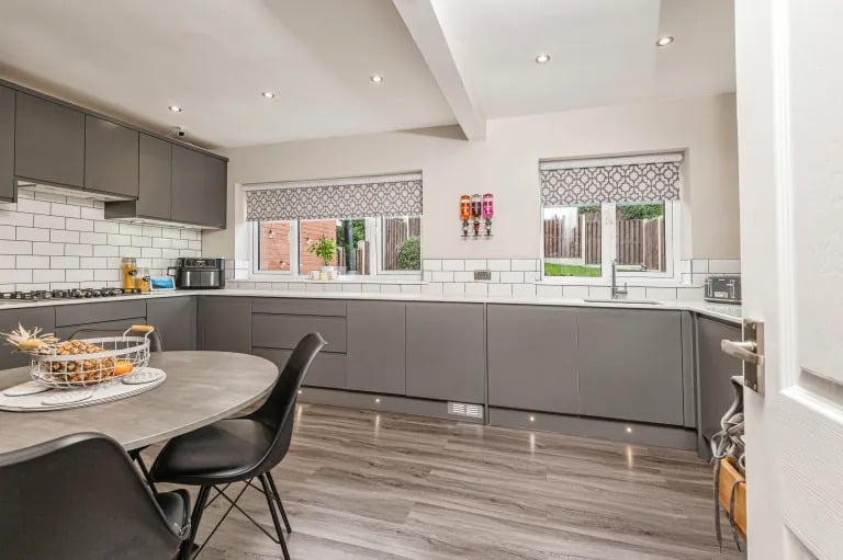 The modern kitchen boasts sleek finishes and high-end appliances,