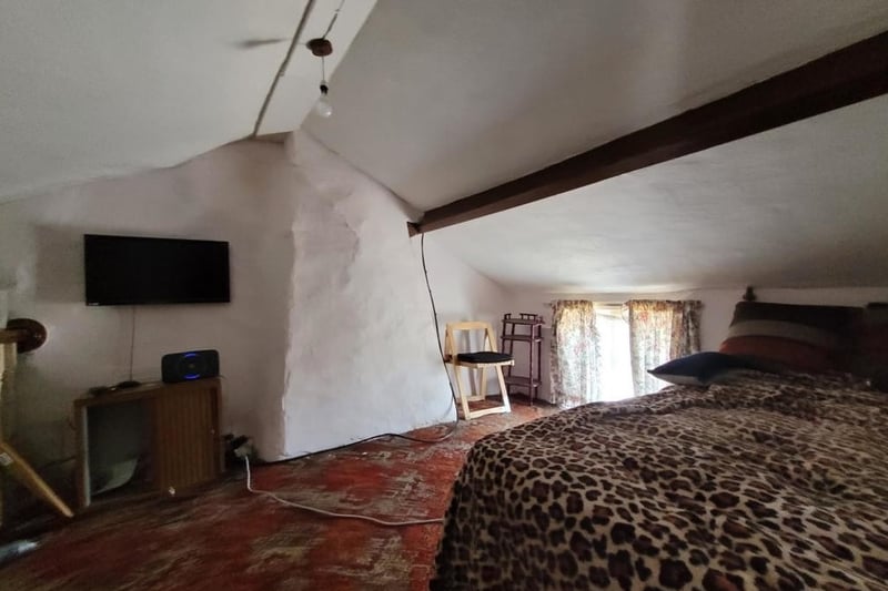 The bedroom tucked away under beams