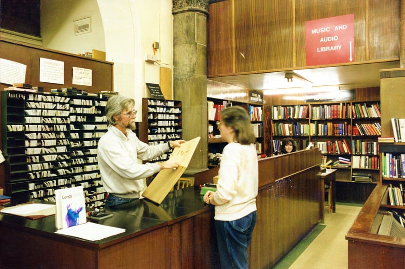 The counter of the Music Library in a corner of the Central Lending department in the Central Library. Behind the counter are rows of cassettes ready for loan for which the boxes will be out on display. Records were also available. 