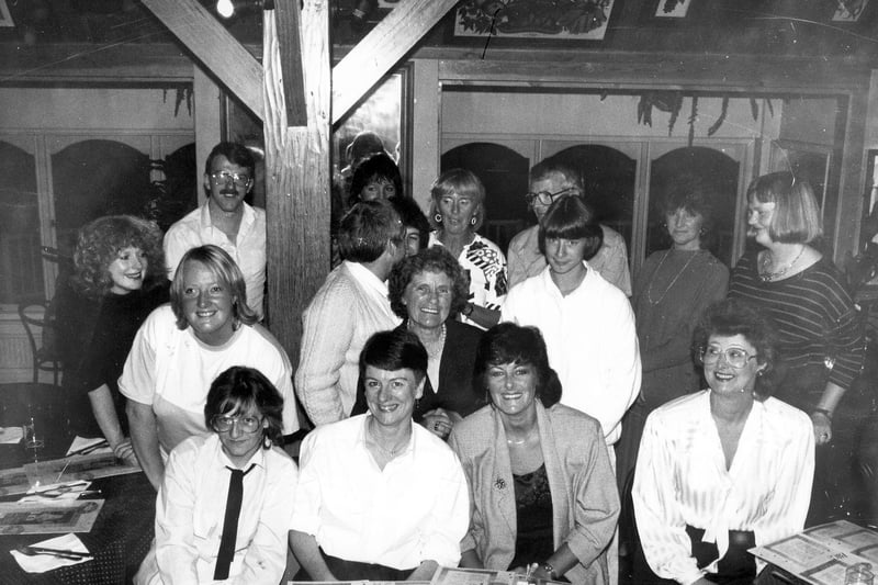 A group portrait of staff and local residents of the Alston Lane centre on the occasion of a farewell party for the central organiser, Faye White, seen in the centre, in November 1987. She had worked as the central organiser for four years but prior to that she had five years experience as a schools social worker attached to Seacroft Park, Foxwood and Parklands Schools. She had also spent four years with the Family Service Unit in Seacroft.