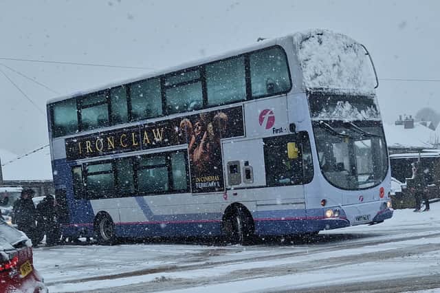 School pupils push a bus stuck in snow in Crosspool. Picture: David Kessen, National World