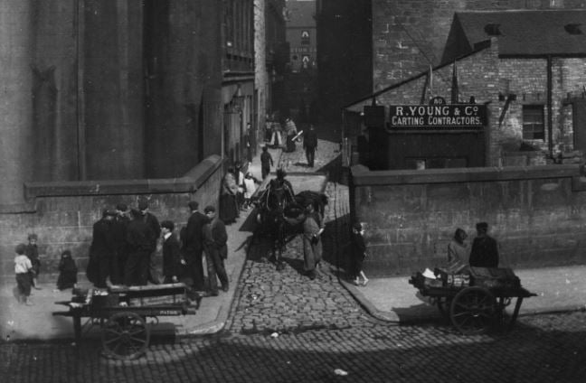 Sharps Lane from Stobcross Street showing street traders and carts around 1910. 