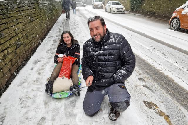 A dad and daughter head off to go sledging in Sheffield. Picture: David Kessen, National World