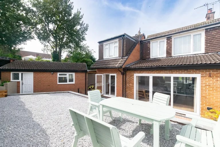 The landscaped rear garden has a raised large patio area.