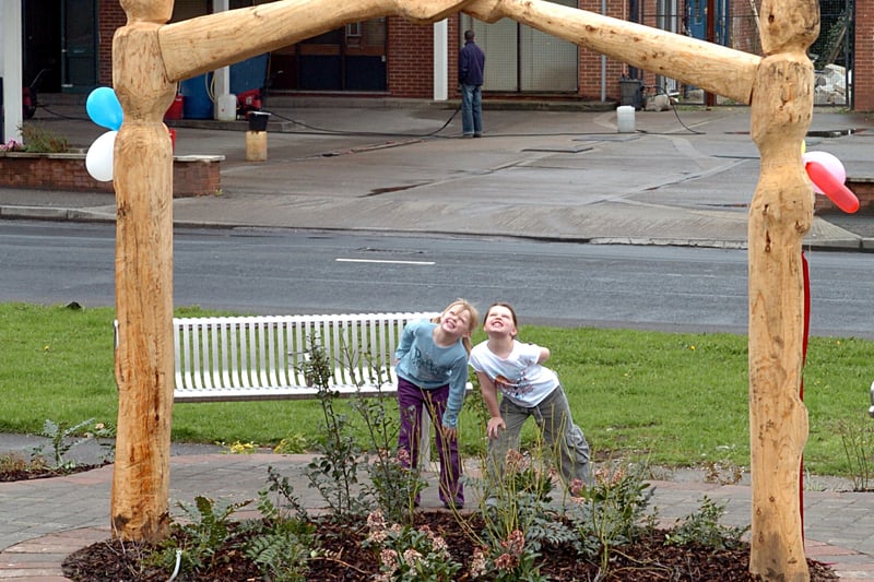 Katie Richards and her sister Casey take a close look at the new wood statue  on the Fairfield estate in April 2006.