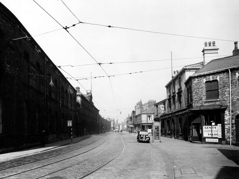 View looking along Hunslet Road from the junction with Dawbridge Street. W. Murrell hairdressers, The Royal George Hotel and Walton's fish and chip shop visible. Pictured in August 1947.