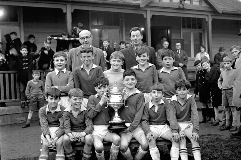Team picture of St Patrick's primary school football team with trophy in April 1964. 