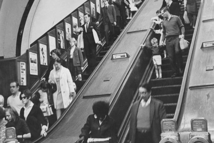 Passengers on an escalator at Piccadilly Circus underground station in London, August 1966. (Photo by Peter King/Fox Photos/Hulton Archive/Getty Images)