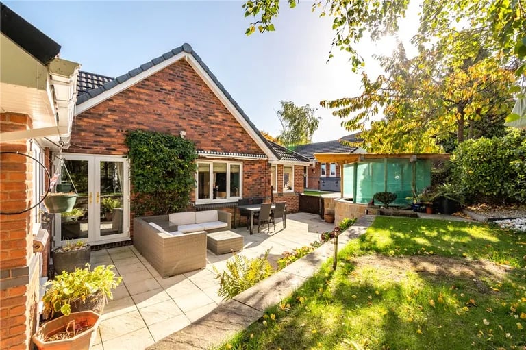A deceptively spacious bungalow with impressive gardens is on the market.
