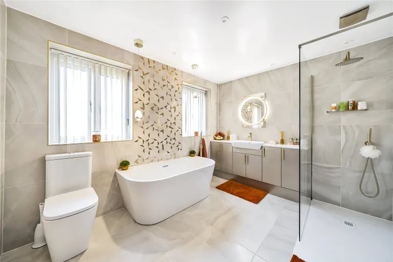 The property has a luxurious bathroom with separate bath and shower.