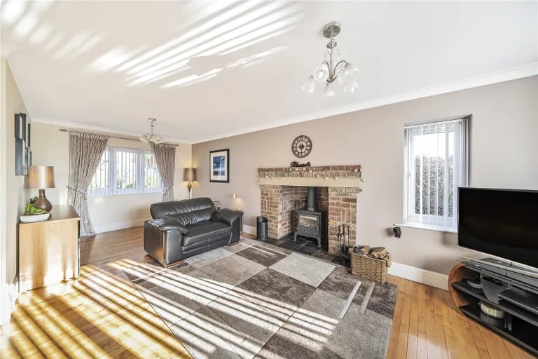 It features large reception rooms and stunning gardens for luxurious family living.
