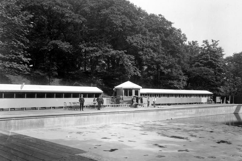 The open-air swimming pool which had been drained. Workmen can be seen to the side of pool working on changing rooms. Pictured in June 1907.