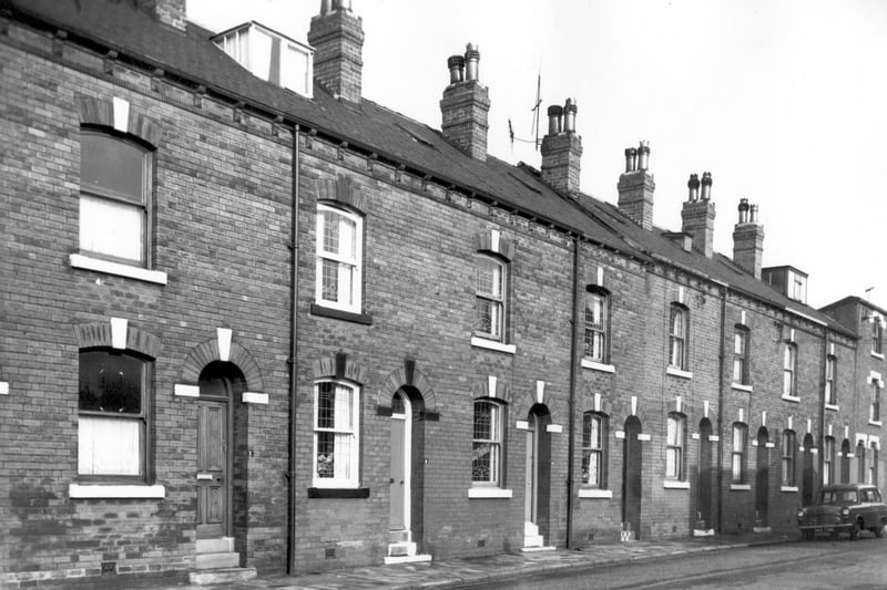 A row of through terraces on Devon Street some of their original leaded windows. No 9 has had a dormer window put in the attic as has no 21. Pictured in October 1966.