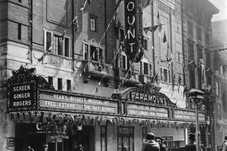  A 1935 photograph of the exterior of the Paramount cinema on Pilgrim Street Newcastle upon Tyne. The cinema is decorated with flags and bunting to celebrate the Silver Jubilee of King George V and Queen Mary. The Paramount is showing the film 'The Gay Divorce' starring Fred Astaire. 