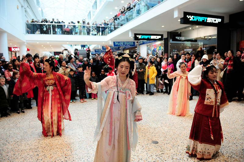 A large crowd watch traditional Chinese dancing