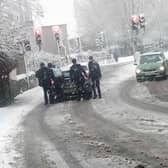 Four schoolboys help push struggling motorists up the hill on West Street, Eckington.