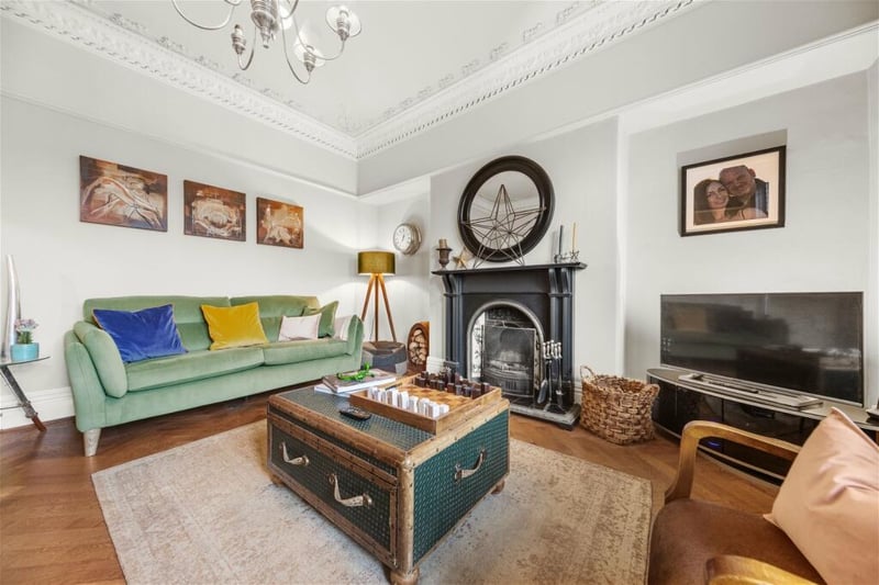 The living room is full of period features and centres around an open fireplace.