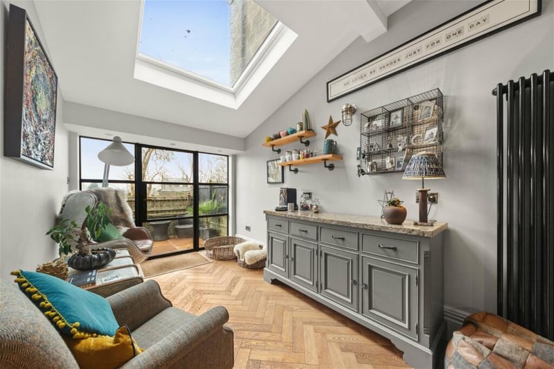 It leads to this gorgeous sitting room with skylight for lots of natural light.