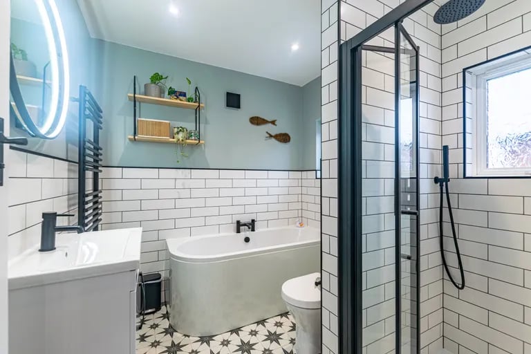 The house bathroom has a deep bathtub and separate shower and is ideal for unwinding after a long day. 