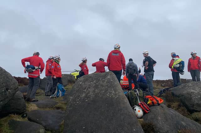 Mountain rescue teams on the scene, with the Yorkshire Air Ambulance visible in the background. Picture: Edale Mountain Rescue