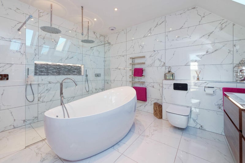 The en-suite bathroom to the principal bedroom has Villeroy and Boch sanitary ware, twin wash hand basins, twin shower heads with walk in/walk out showers and stand alone feature bath. 