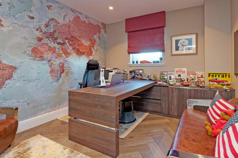 The home office has bespoke built in office furniture including desk and drawer/filing storage. 