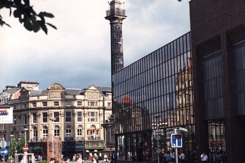 A view of Blackett Street taken in 1988. The photograph has been taken from the left-hand side of Blackett Street looking up the street towards Eldon Buildings. Eldon Square Shopping Centre is to the right with Grey's Monument next to it. 