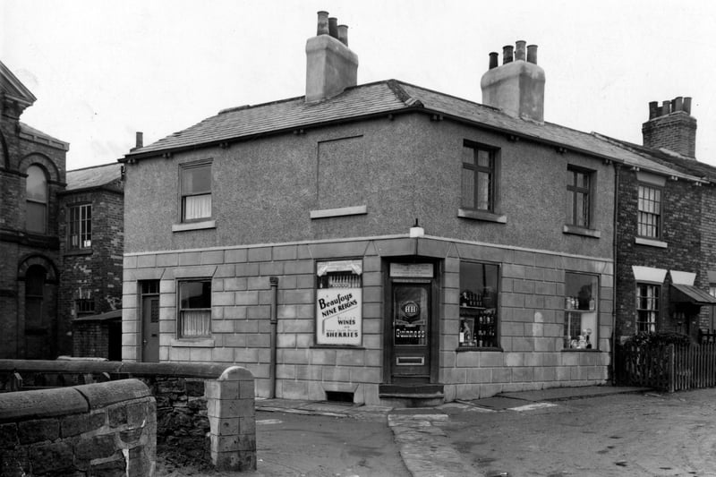 Orson's store on the corner of York Road pictured in March 1954.  The shop windows show bottles of beer and they advertise Guinness and Beaufoys nine reigns wine and sherry. Brick cottages adjoin.