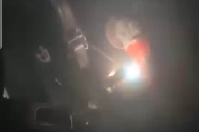 A still from one of the videos posted to Paul's Facebook showing how one of the thieves used an angle grinder to cut off the car's steering lock.