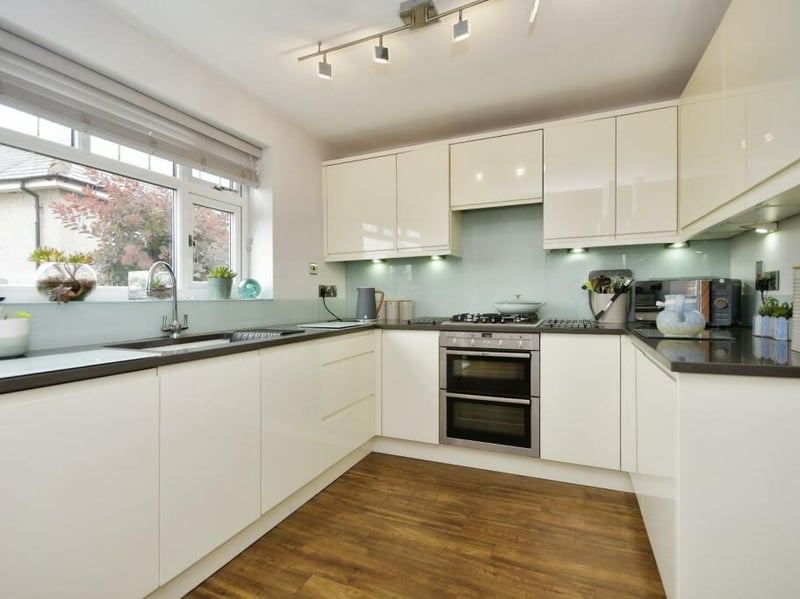 The kitchen has a range of matching high gloss wall and base units, integrated fridge, Neff oven & matching hob along with a Siemens dishwasher. It is finished by a quartz worktop. 