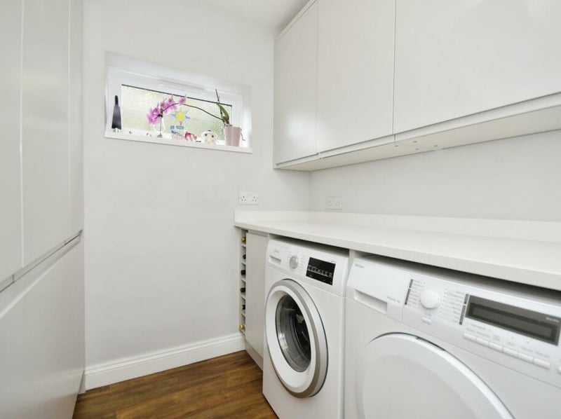 It provides space for a washing machine and tumble dryer along with an integrated large fridge and separate freezer. There is a courtesy door to the integral garage.