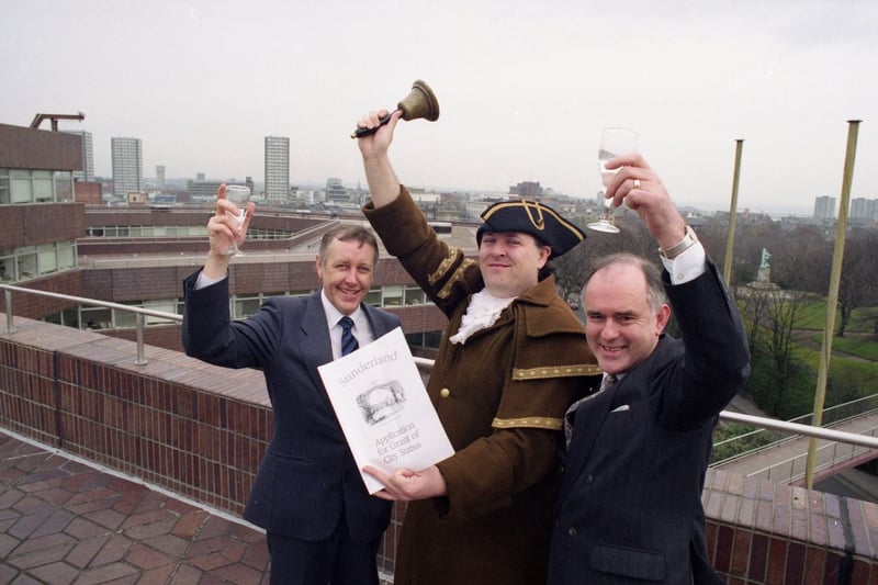Celebrating city status on February 14, 1992, were left to right, Phil Wright, the council's head of marketing; Brian Walsh, town crier; and Geoffrey Key, council chief executive.