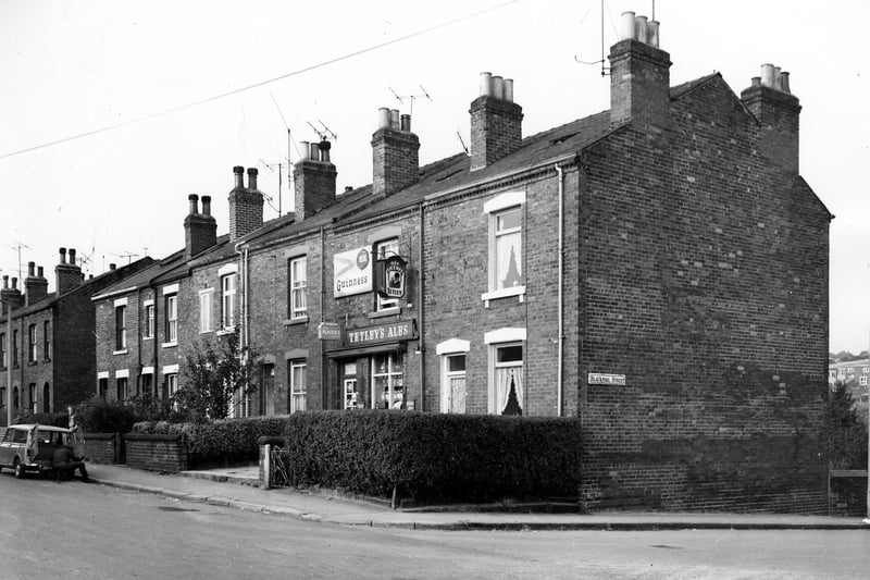 Even numbered properties on Cow Close Road run from the left of this view. Number 40 is visible on the left edge, followed to the right by a gap in the terrace, then numbers 38 to 28. Number 30 is an off licence run by Mr and Mrs Gerrard. Large signs advertising Guinness and Tetley's can be seen. Blackpool Street runs to the right edge. Pictured in October 1969.
