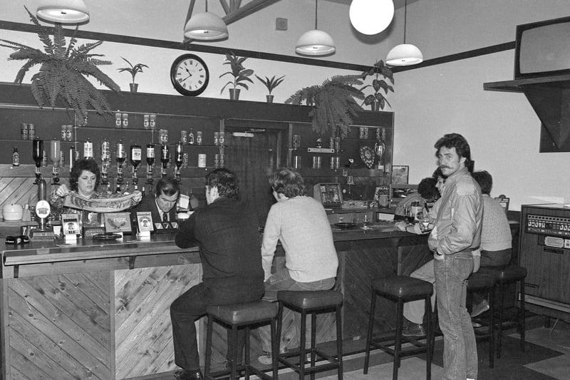 Customers and staff at the bar in this scene from March 1982.