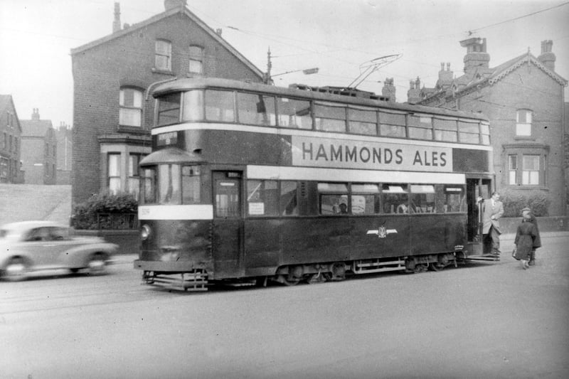 Tram no 509 on Dewsbury Road travelling on route no 9. Advert for 'Hammonds Ales' can be seen on side of tram. Pictured in September 1954.